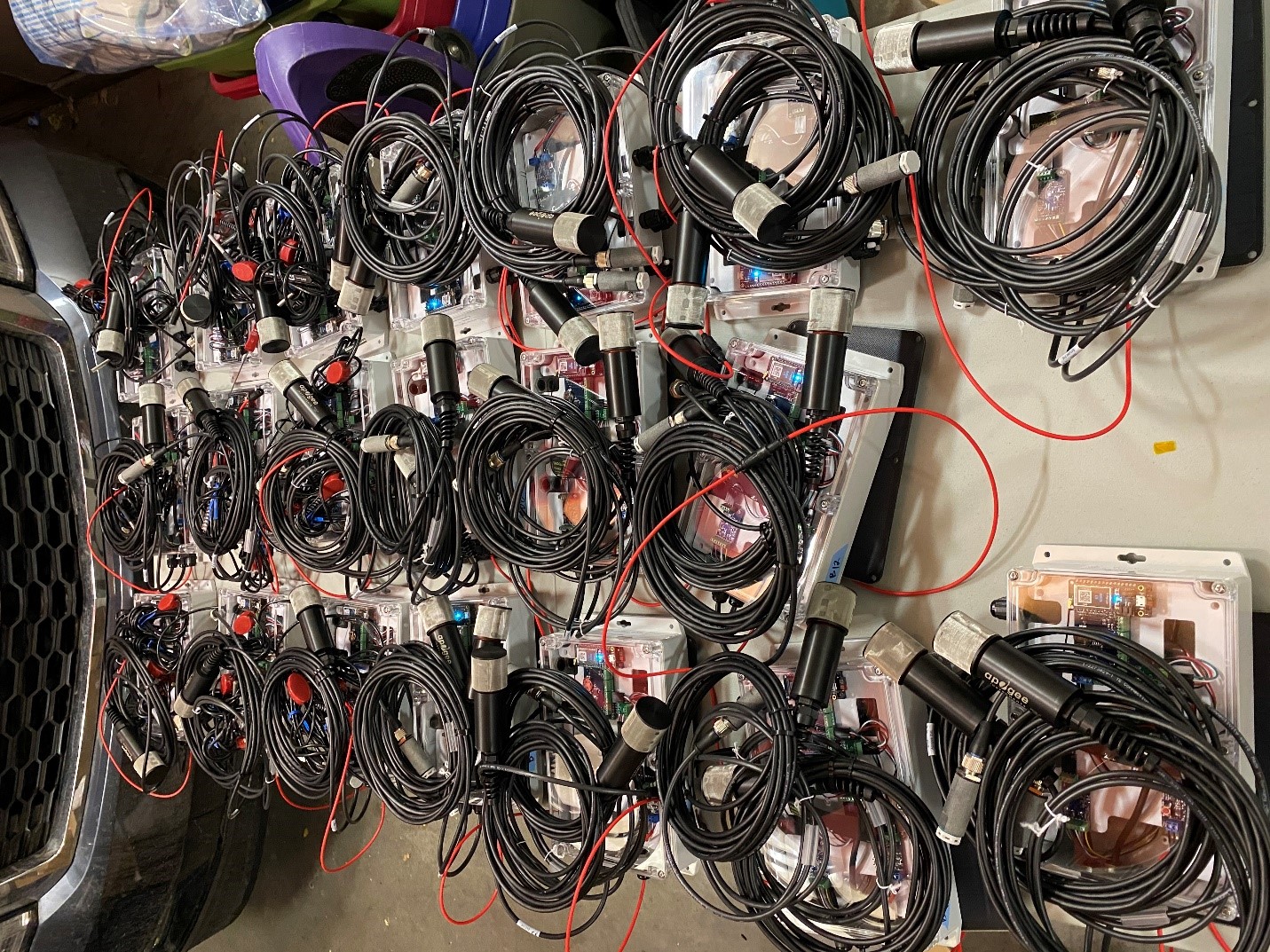 over 20 sensor equipment setups lined up on a cement floor