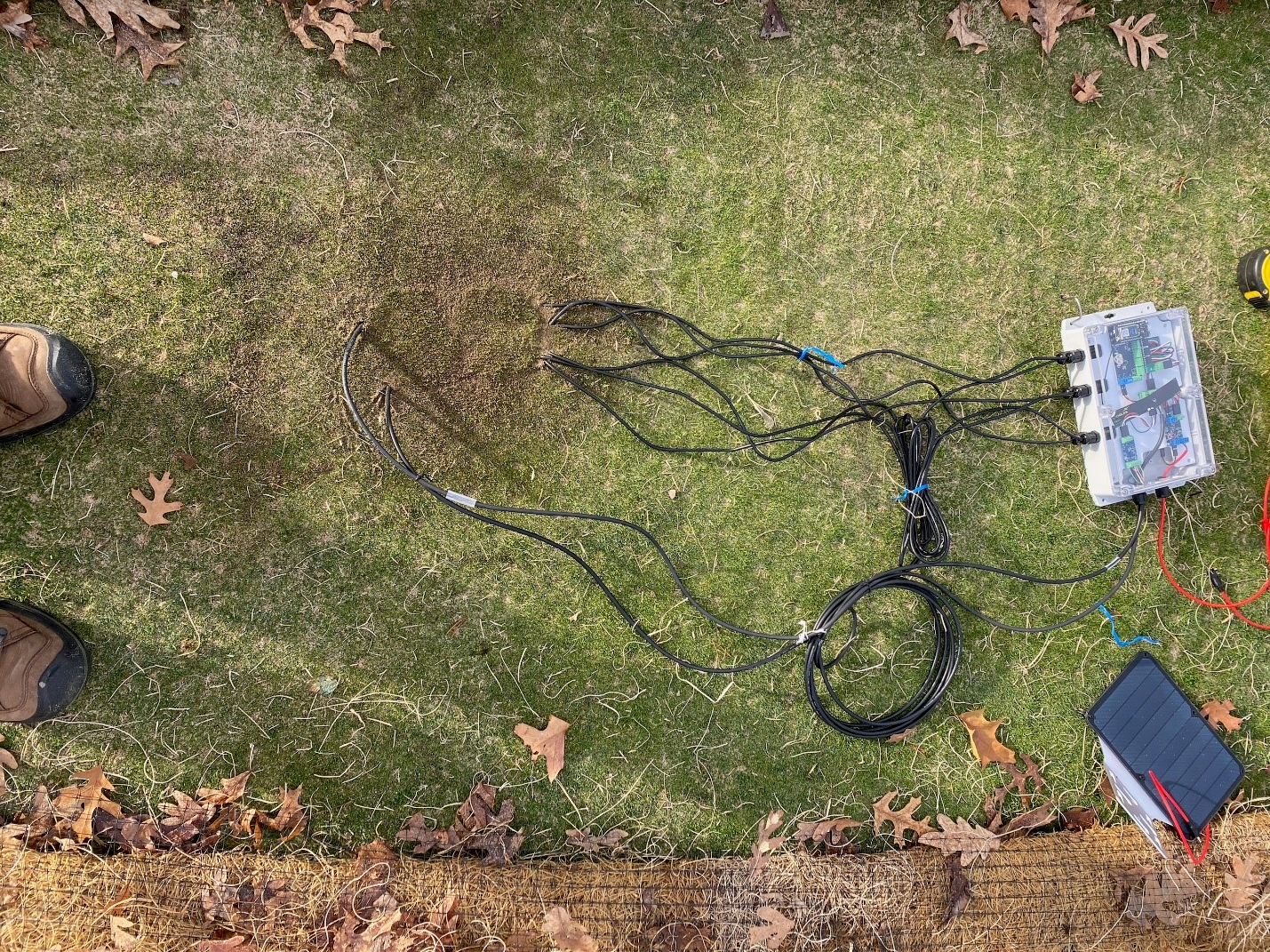 Wires buried beneath turf connected to sensor equipment