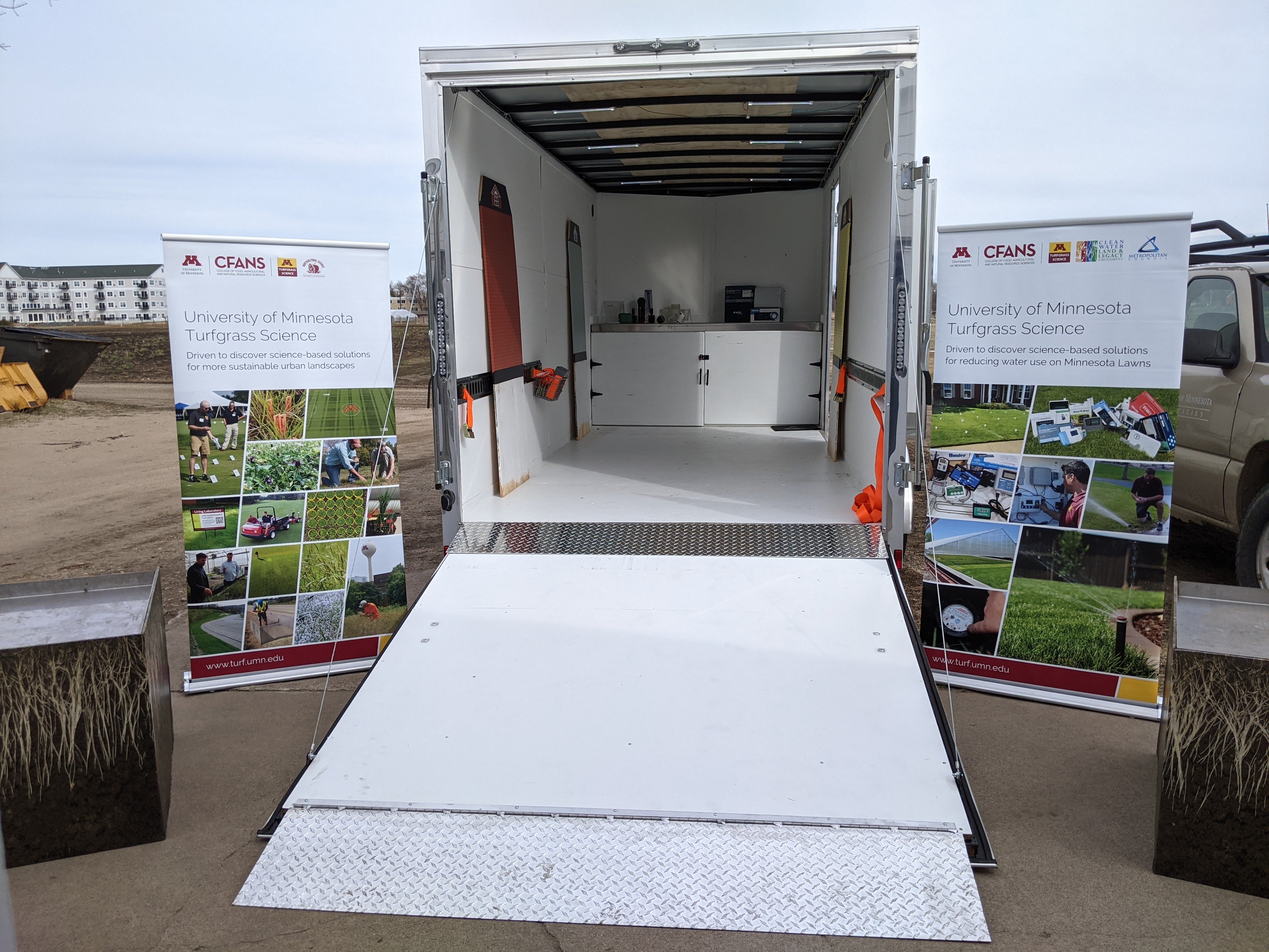 Open trailer with ramp and posters to each side