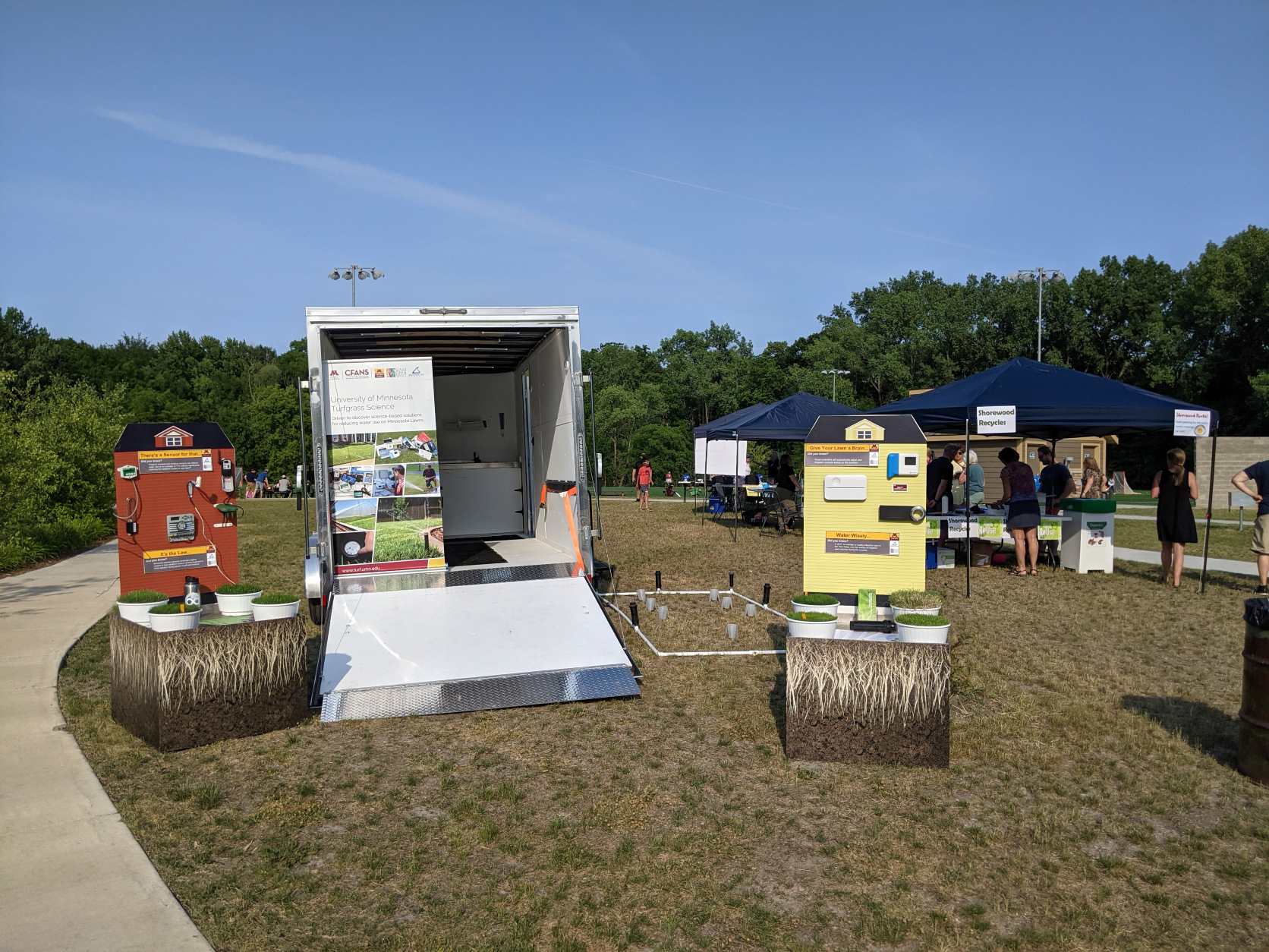 a trailer with educational turfgrass displays outside at an event
