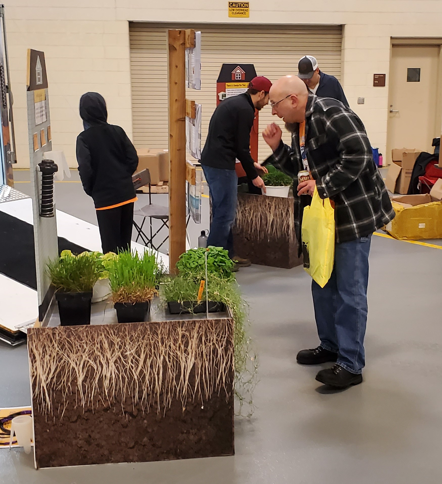 person looking at a turfgrass display at an event