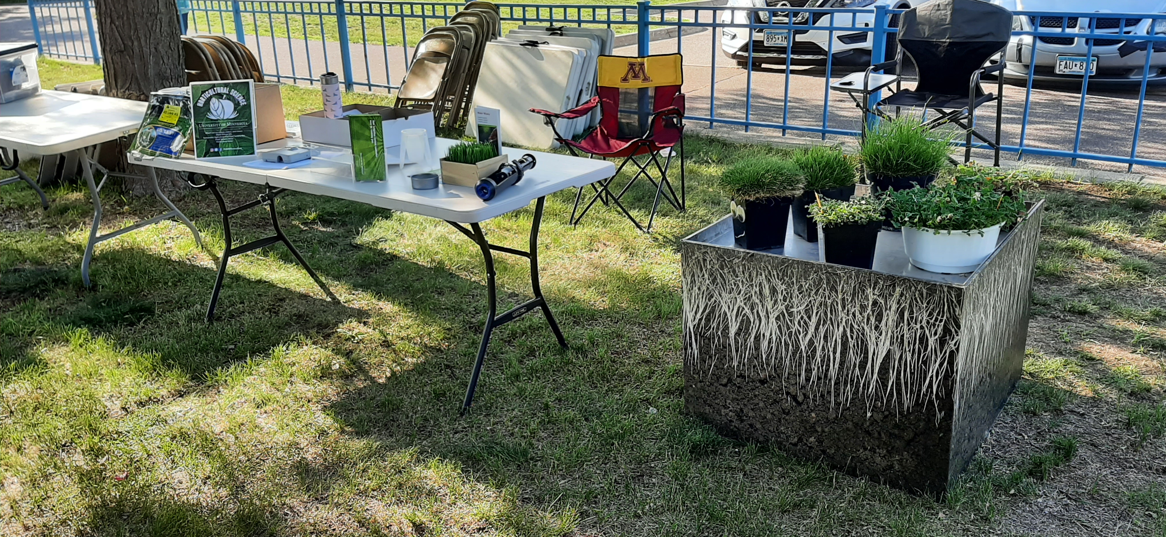 a table and turfgrass display materials at an outdoor event