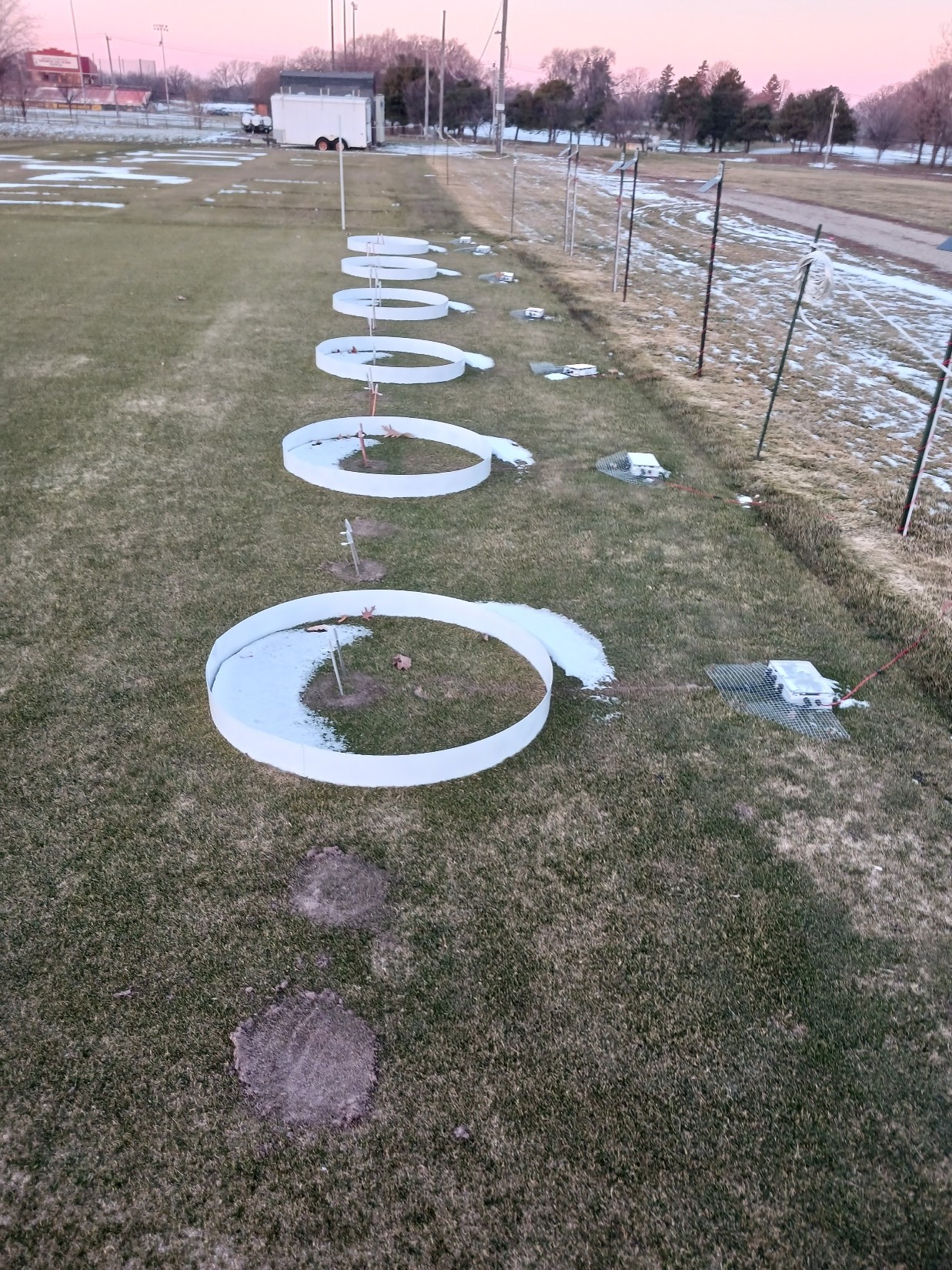 turfgrass research plots with plastic circular structures