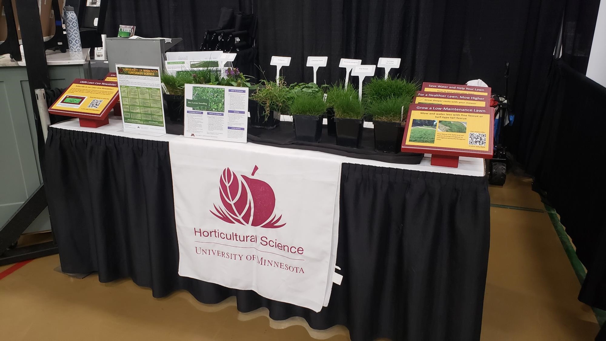 a turfgrass educational display with live plants, signs and handouts