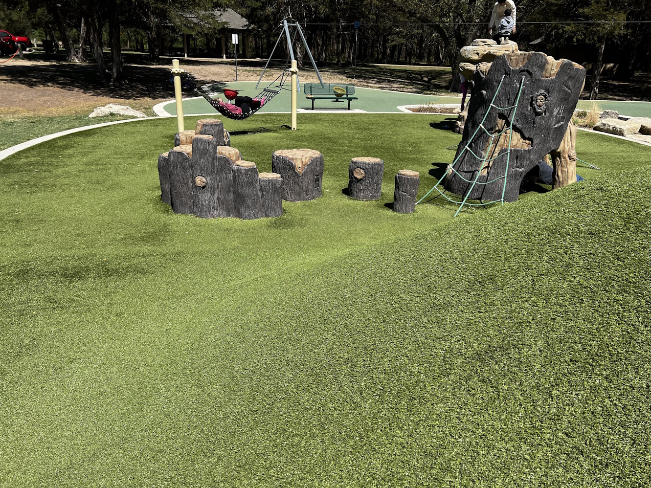 a children's playground with artificial grass