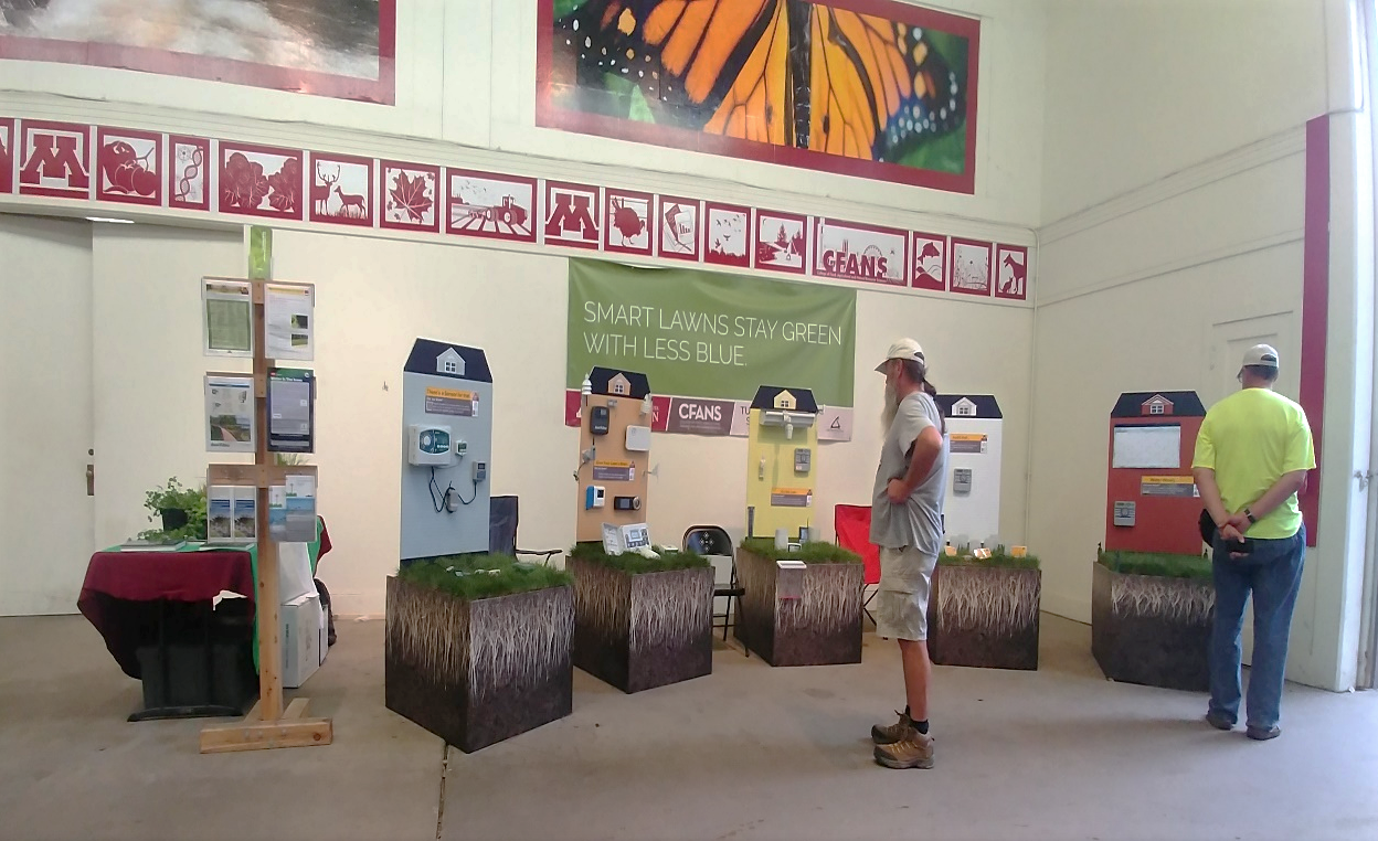 Two fairgoers looking at irrigation display at the 2018 Minnesota State Fair